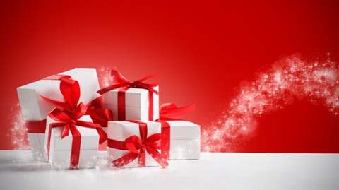 Group of small gifts wrapped with red ribbon on white table with copy space. Five little presents for christmas or birthday party. Set of gift boxes over a red shiny background.